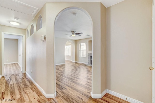 7949 Long Beach St, Las Vegas, NV 89139 - hall featuring arched walkways, light wood-type flooring, and baseboards