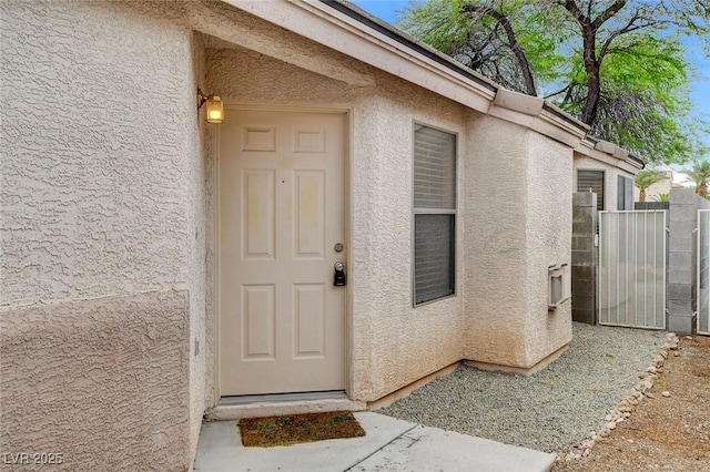 7949 Long Beach St, Las Vegas, NV 89139 - doorway to property with stucco siding and a gate