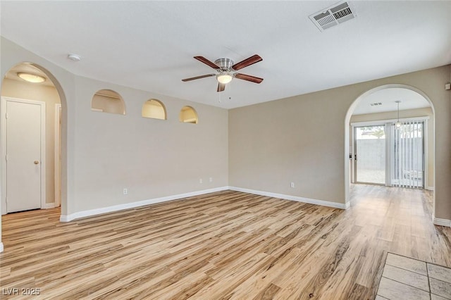 7949 Long Beach St, Las Vegas, NV 89139 - unfurnished room with arched walkways, ceiling fan, light wood-type flooring, baseboards, and a smoke detector