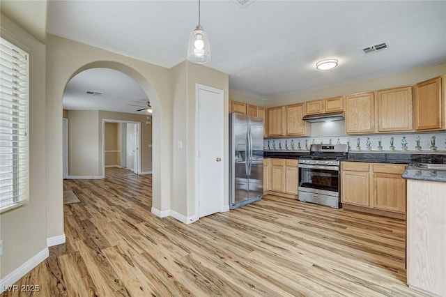 7949 Long Beach St, Las Vegas, NV 89139 - kitchen featuring stainless steel appliances, light wood-style floors, arched walkways, and baseboards