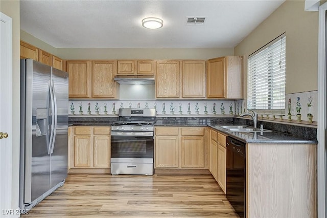7949 Long Beach St, Las Vegas, NV 89139 - kitchen with stainless steel appliances, a sink, light brown cabinets, under cabinet range hood, and dark countertops