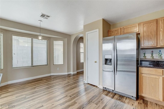 7949 Long Beach St, Las Vegas, NV 89139 - kitchen featuring stainless steel refrigerator with ice dispenser, arched walkways, light wood-style floors, and baseboards