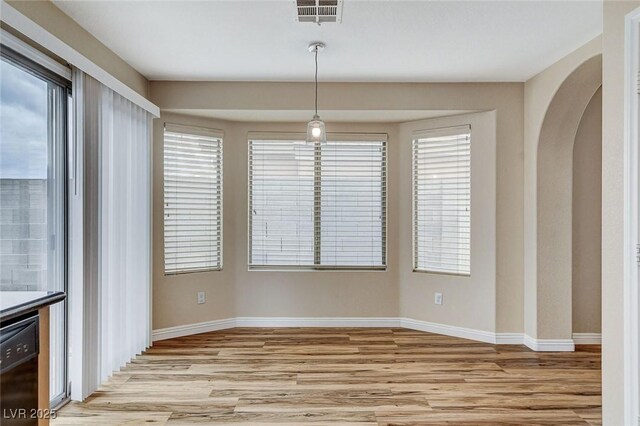 7949 Long Beach St, Las Vegas, NV 89139 - unfurnished dining area with light wood-type flooring, baseboards, and arched walkways