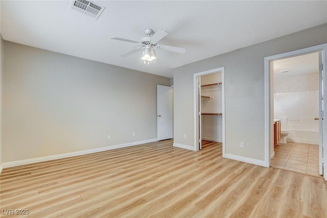 7949 Long Beach St, Las Vegas, NV 89139 - unfurnished bedroom with light wood-type flooring, a spacious closet, baseboards, a closet, and connected bathroom