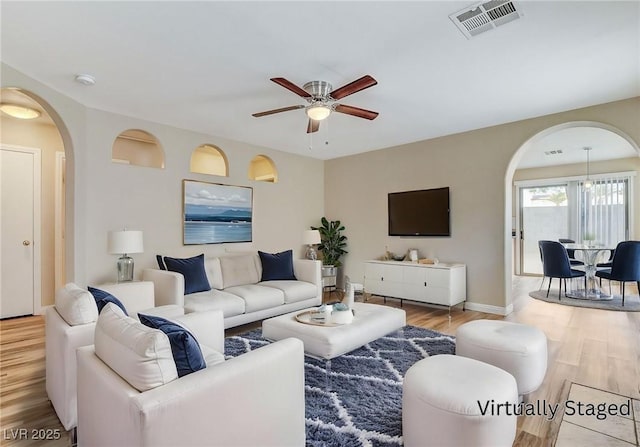 7949 Long Beach St, Las Vegas, NV 89139 - living area with arched walkways, ceiling fan, wood finished floors, and baseboards