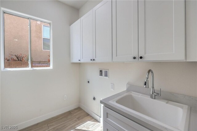 1964 Oliver Springs St, Henderson, NV 89052 - laundry room featuring electric dryer hookup, washer hookup, cabinet space, light wood finished floors, and baseboards