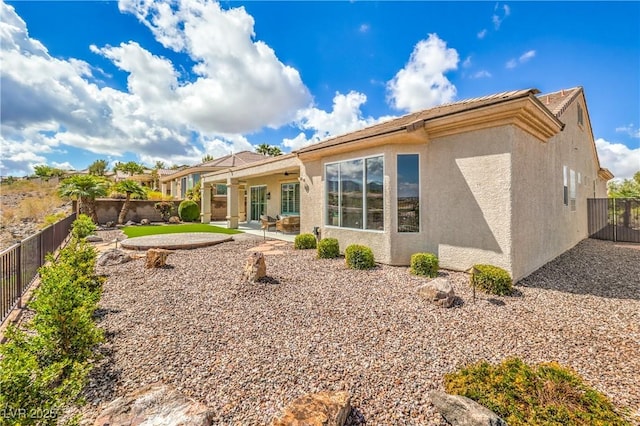 1964 Oliver Springs St, Henderson, NV 89052 - rear view of house with stucco siding, a patio area, and a fenced backyard