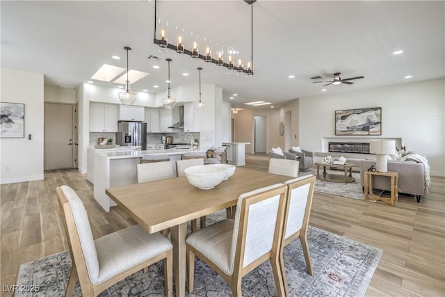 1964 Oliver Springs St, Henderson, NV 89052 - dining space with recessed lighting, light wood-style floors, a ceiling fan, baseboards, and a glass covered fireplace