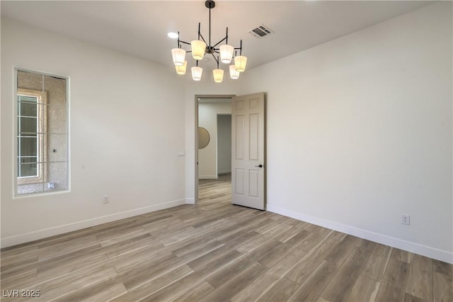 1964 Oliver Springs St, Henderson, NV 89052 - unfurnished room featuring light wood finished floors, a chandelier, and baseboards