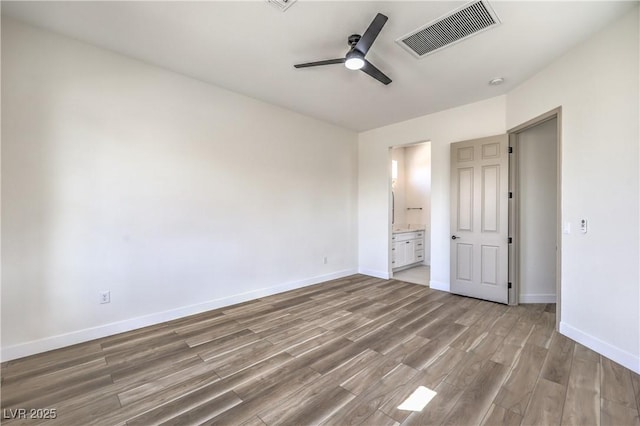 1964 Oliver Springs St, Henderson, NV 89052 - unfurnished bedroom featuring wood finished floors, baseboards, ensuite bath, and ceiling fan