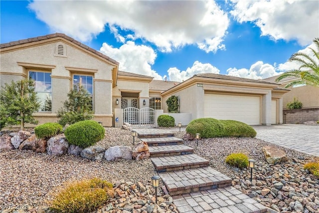1964 Oliver Springs St, Henderson, NV 89052 - view of front of house with a garage, decorative driveway, and stucco siding