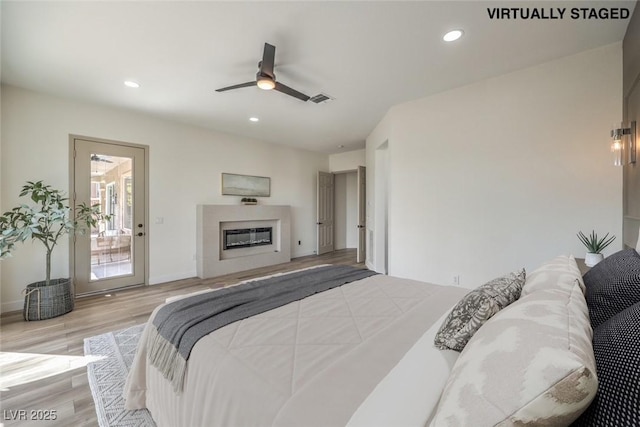 1964 Oliver Springs St, Henderson, NV 89052 - bedroom featuring wood finished floors, a glass covered fireplace, recessed lighting, and a ceiling fan