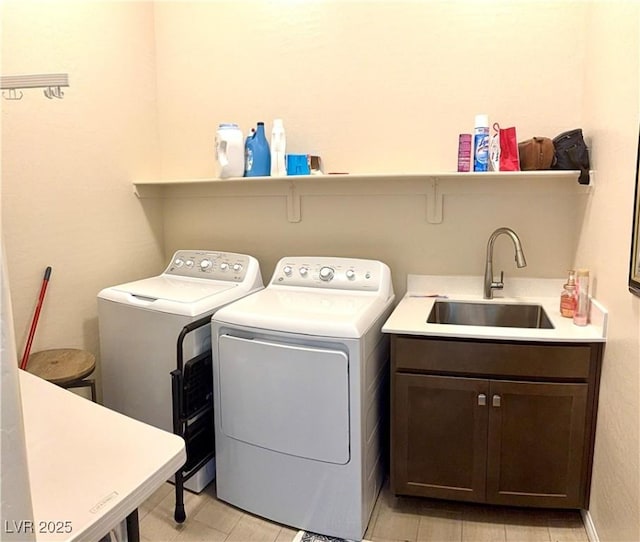 laundry area featuring washing machine and dryer and cabinet space