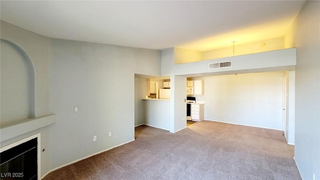 unfurnished living room with carpet flooring, baseboards, and a fireplace