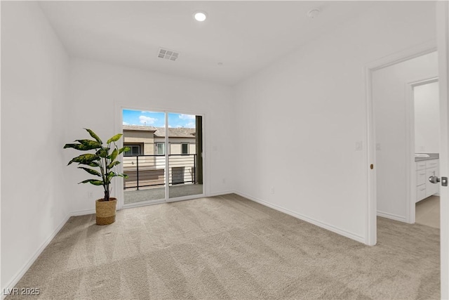 spare room featuring light colored carpet, baseboards, and recessed lighting