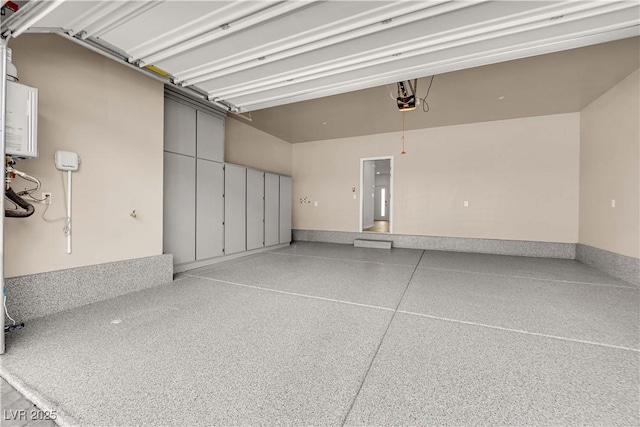 garage featuring a garage door opener and water heater