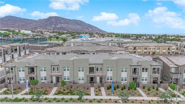 view of mountain background featuring nearby suburban area