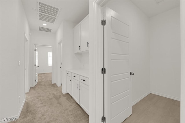 hall with baseboards, light carpet, and recessed lighting
