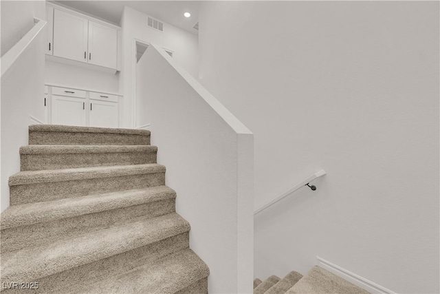 stairs featuring recessed lighting
