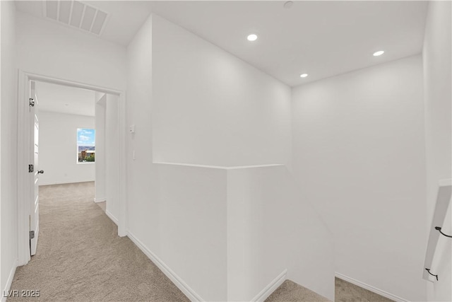 corridor featuring carpet, baseboards, and recessed lighting