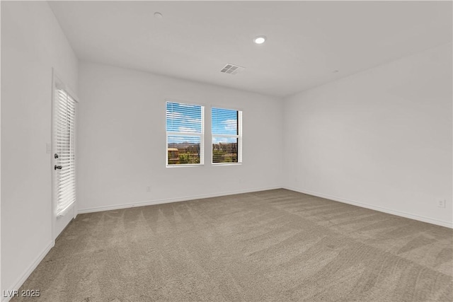 carpeted spare room featuring plenty of natural light, baseboards, and recessed lighting
