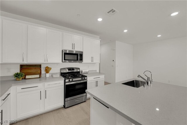 334 Laurel Peak Dr, Henderson, NV 89015 - kitchen featuring stainless steel appliances, a sink, white cabinetry, and recessed lighting