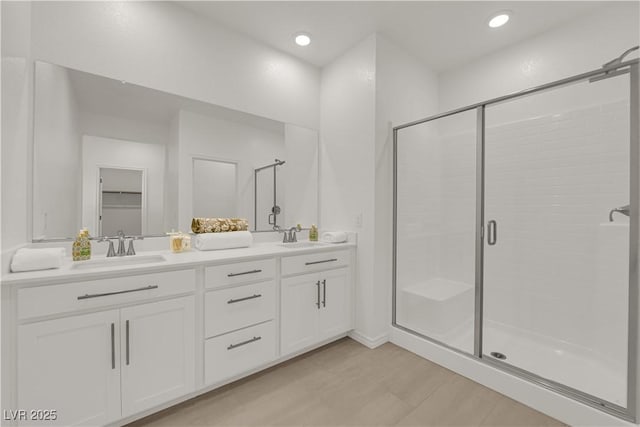 334 Laurel Peak Dr, Henderson, NV 89015 - full bathroom with a shower stall, double vanity, wood finished floors, and recessed lighting