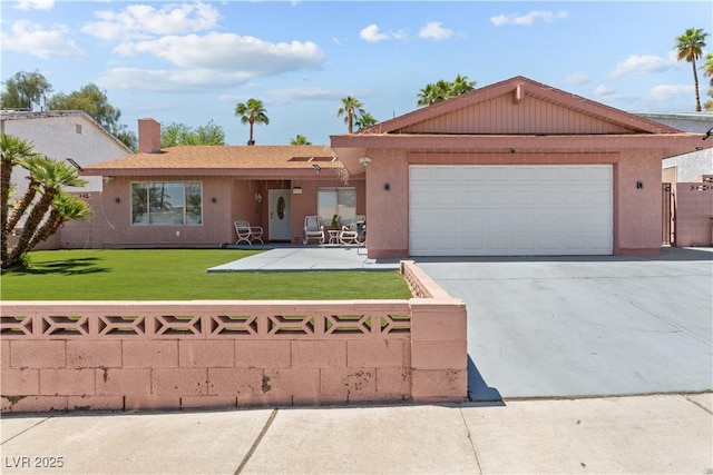 ranch-style house featuring an attached garage, driveway, and stucco siding