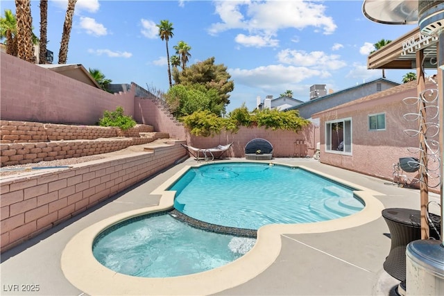 view of swimming pool featuring a fenced backyard, a patio, and a pool with connected hot tub