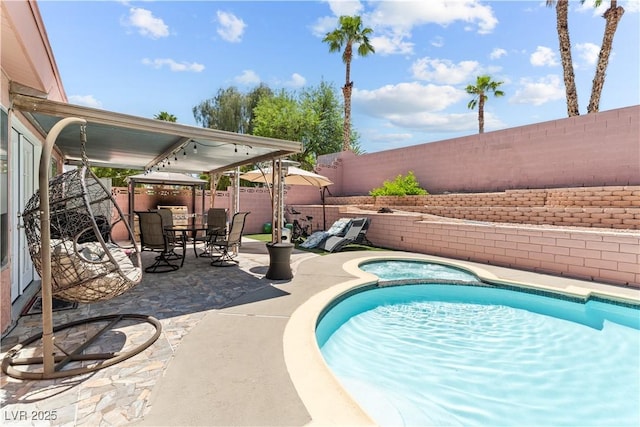 view of pool with a fenced backyard, a patio area, a pool with connected hot tub, a gazebo, and outdoor dining area