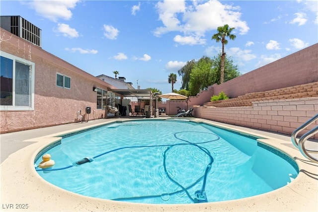 view of swimming pool with a fenced backyard and a patio