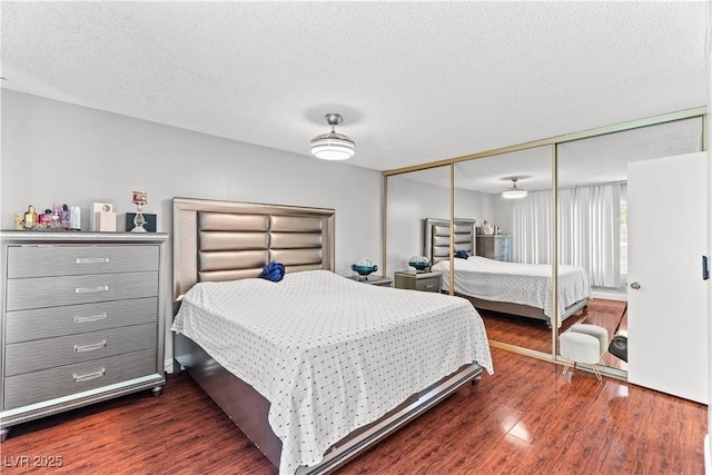 bedroom featuring wood finished floors, a closet, and a textured ceiling