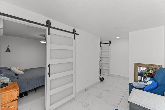 hall with a barn door, marble look tiles, recessed lighting, and baseboards