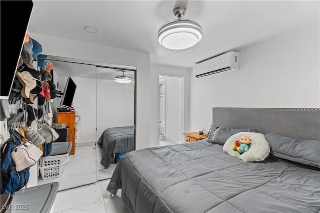 bedroom with a wall mounted air conditioner, marble look tiles, and a closet