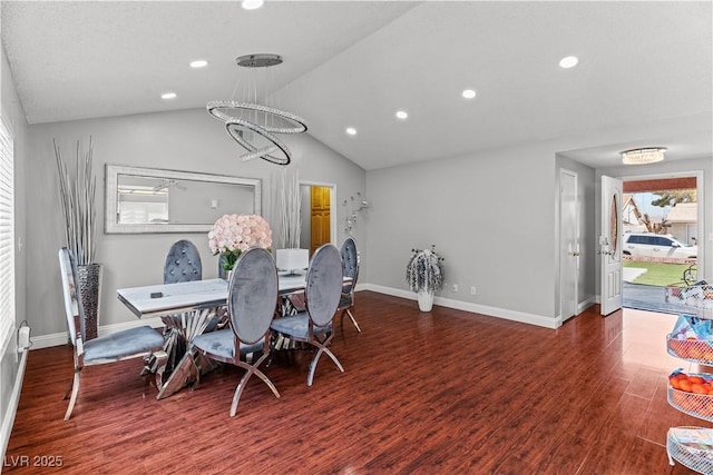 dining space featuring a chandelier, lofted ceiling, recessed lighting, wood finished floors, and baseboards