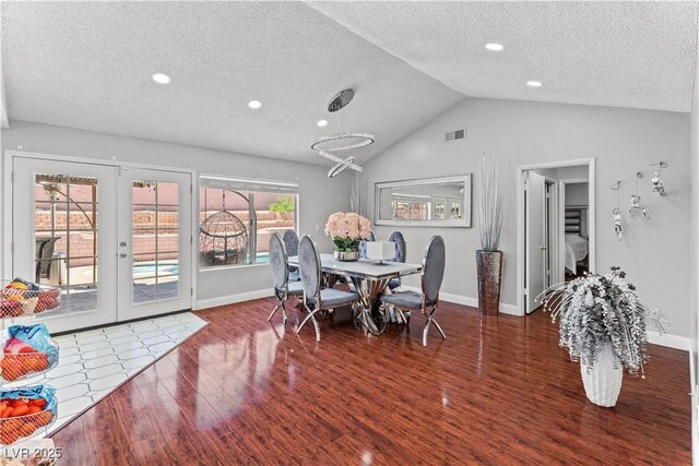 dining area with wood finished floors, a textured ceiling, vaulted ceiling, baseboards, and recessed lighting