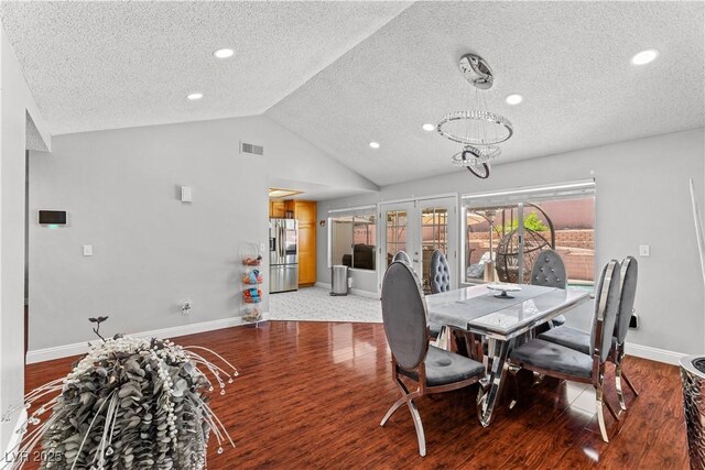 dining room with a textured ceiling, baseboards, wood finished floors, vaulted ceiling, and recessed lighting
