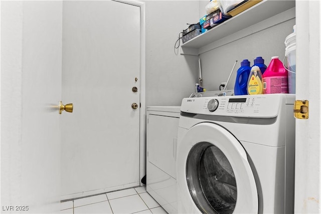 laundry room featuring independent washer and dryer and light tile patterned flooring