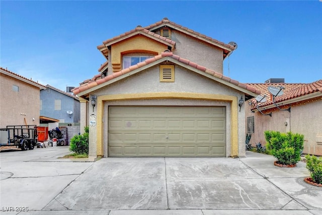 view of front of home featuring concrete driveway, stucco siding, and a tile roof
