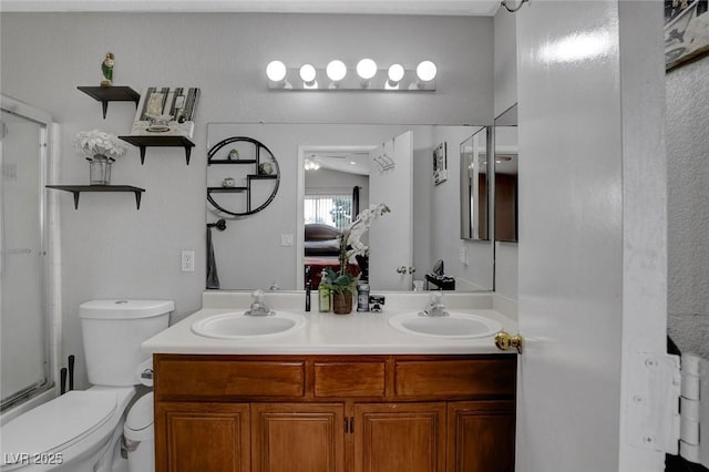 full bath featuring an enclosed shower, toilet, and double vanity