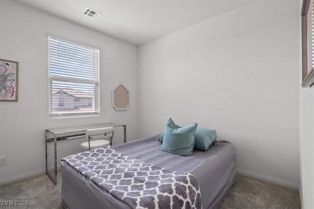 carpeted bedroom featuring baseboards