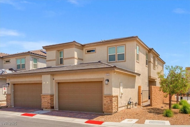 view of property with stucco siding, stone siding, and a garage