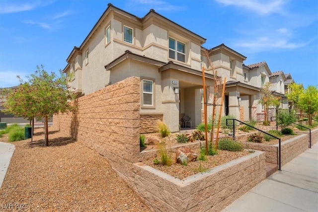 view of front of house featuring stucco siding and a residential view