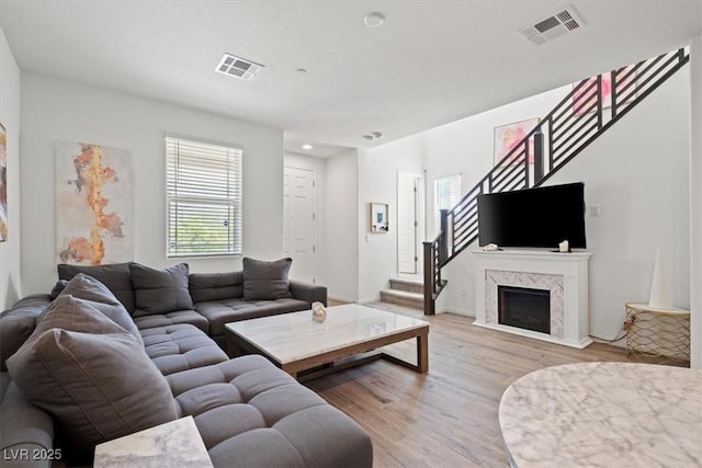 4526 Cloudrest Peak St, North Las Vegas, NV 89031 - living area with light wood-style flooring, stairs, and a fireplace