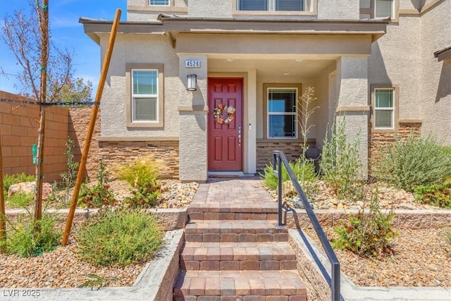 4526 Cloudrest Peak St, North Las Vegas, NV 89031 - property entrance with stucco siding, fence, and stone siding