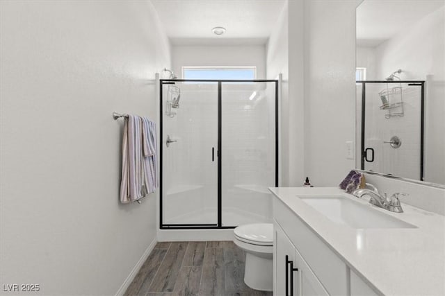 4526 Cloudrest Peak St, North Las Vegas, NV 89031 - full bathroom featuring wood finished floors, a shower stall, toilet, and vanity