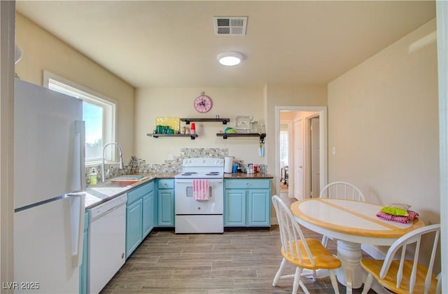533 Date St, Boulder City, NV 89005 - kitchen with white appliances, blue cabinets, a sink, light wood-style flooring, and open shelves