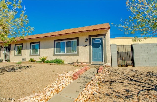 533 Date St, Boulder City, NV 89005 - view of front of home with stucco siding, fence, and a gate