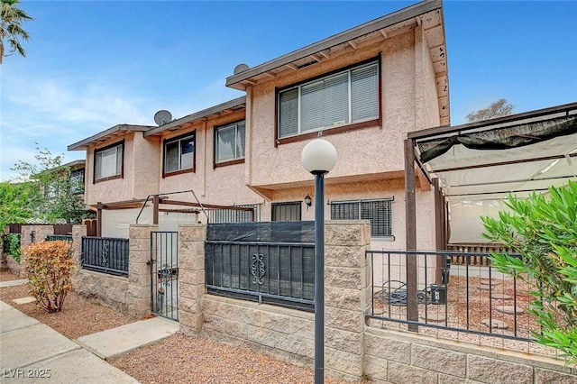 4339 Spencer St Unit 15, Las Vegas, NV 89119 - multi unit property featuring a fenced front yard, stucco siding, and a gate