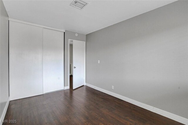 4339 Spencer St Unit 15, Las Vegas, NV 89119 - unfurnished bedroom featuring baseboards, wood finished floors, and a closet